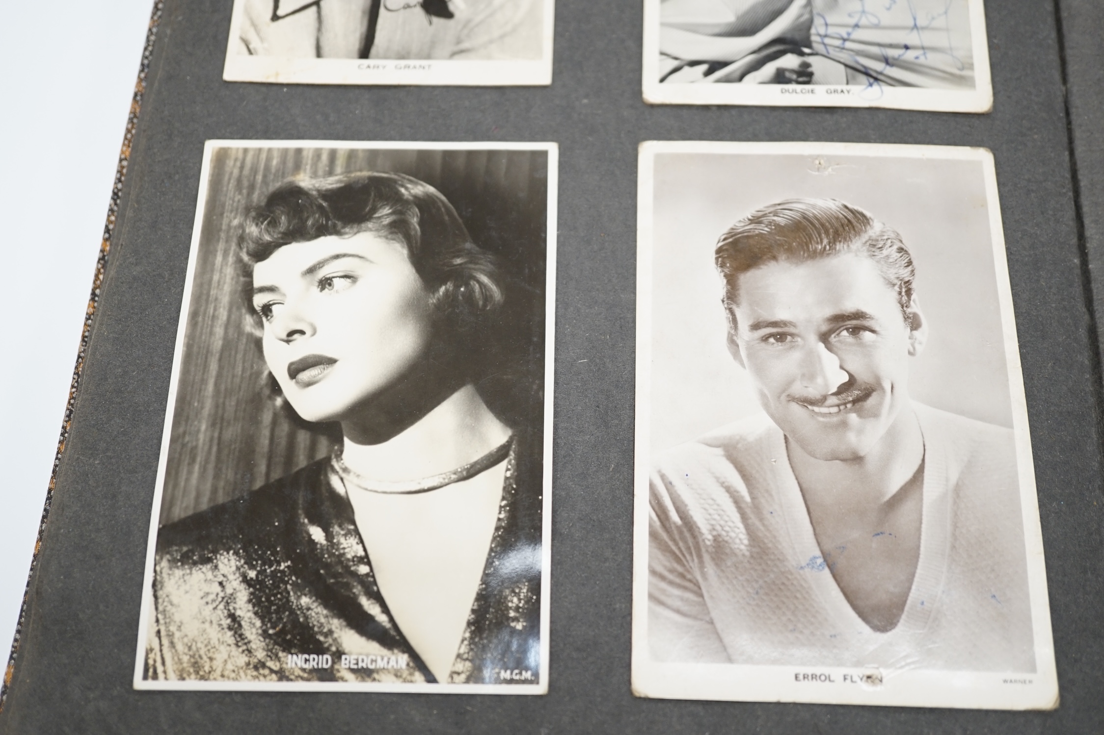 A vintage black and white photograph album with some autographs including Lucille Ball and Margaret O’Brien